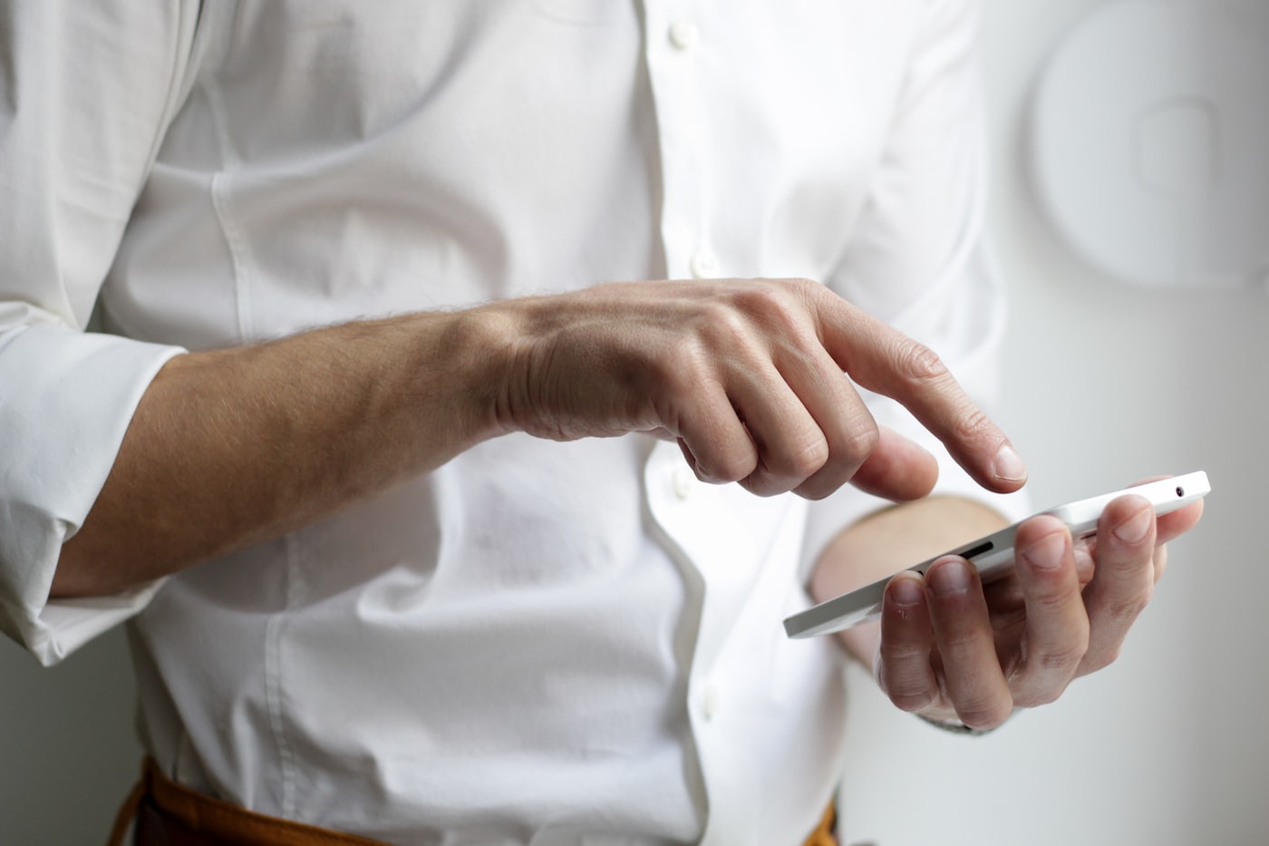 A hand holding a phone with signal bars